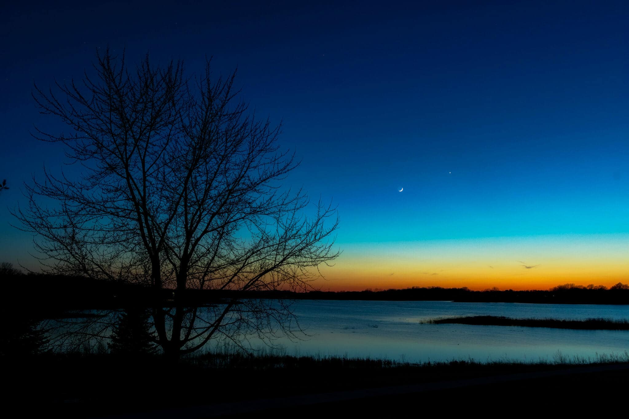 Moon over Pleasant Creek Lake in Iowa